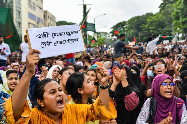 Students chant slogans while they block the Shahbag