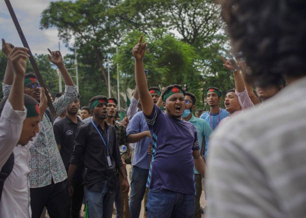 Students shout slogans during a protest against quotas in