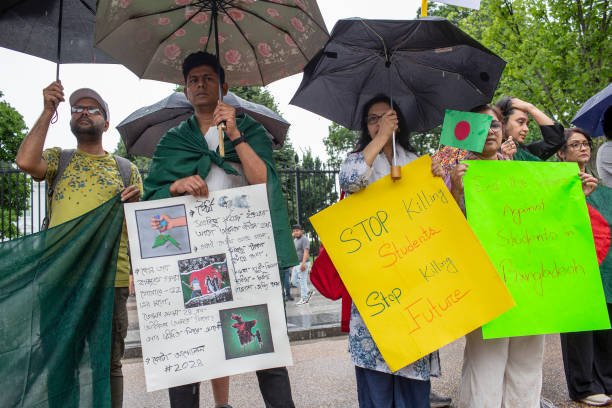Bangladeshi students gather with banners and Bangladeshi