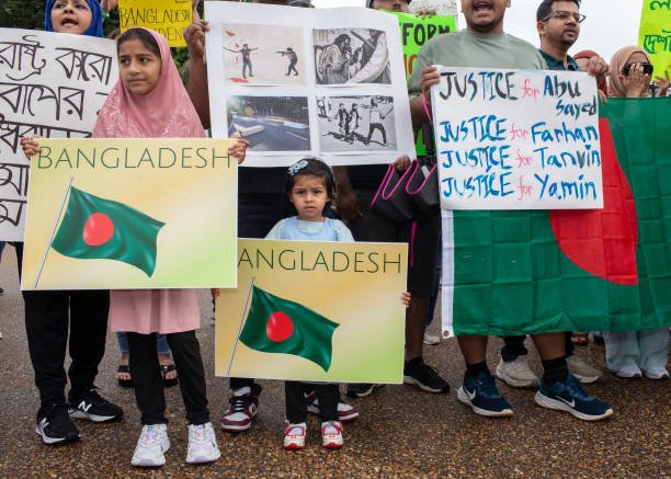 Bangladeshi students gather with banners and Bangladeshi