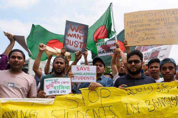 Bangladeshis residents in South Korea hold placards during a