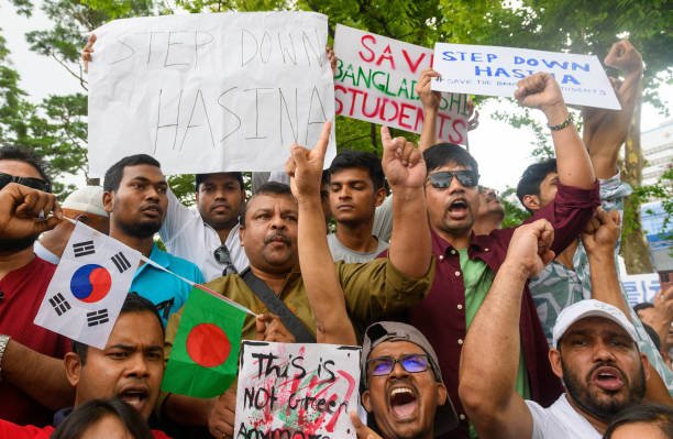 Bangladeshis residents in South Korea hold placards during a