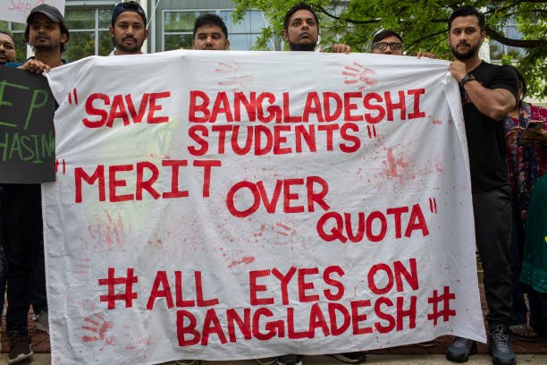 Bangladeshi people holding a sign with Save Bangladeshi