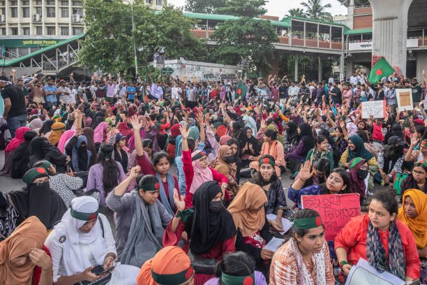 Protesters chant slogans and hold placards expressing their