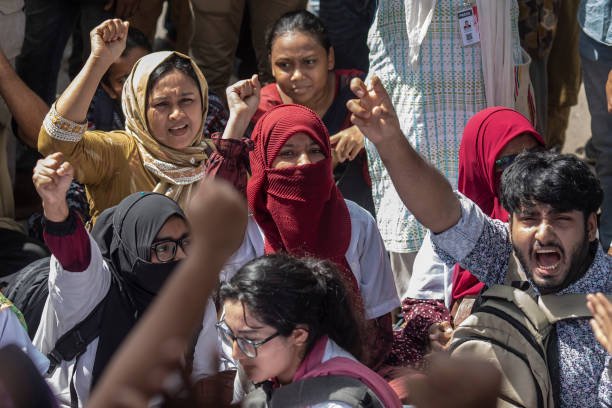 Protesters shout slogans during the demonstration outside