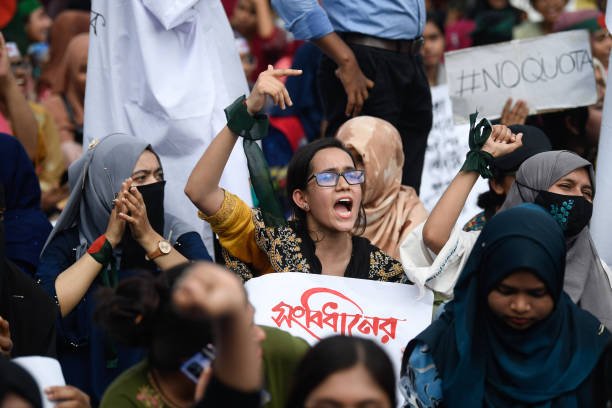 A protester chant slogans and holds a placard expressing