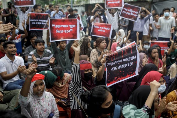 Student activists shout slogan as they protest during a '