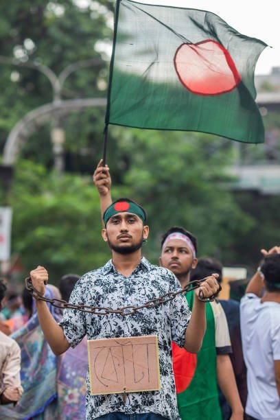 A protester holds a chain and a placard during the