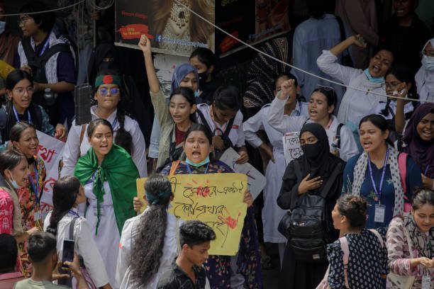 Anti-quota student supporters shout slogans in the road at