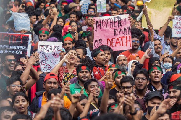 Protesters hold placards expressing their opinion during a