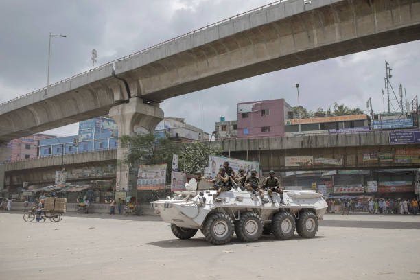 Members of the Bangladesh Army gesture patrol in an armored