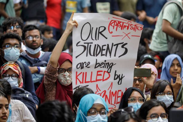Student activists showing placard as they protest during a '