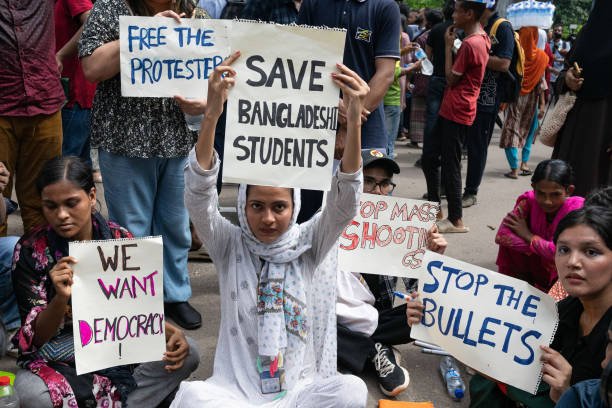 Protesters hold placards during the demonstration outside