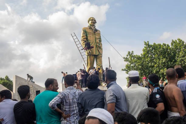 Anti-government protesters gathered at the base of a statue