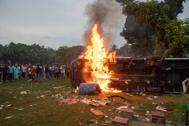 Anti-government protestors set fire to a bus in the Prime