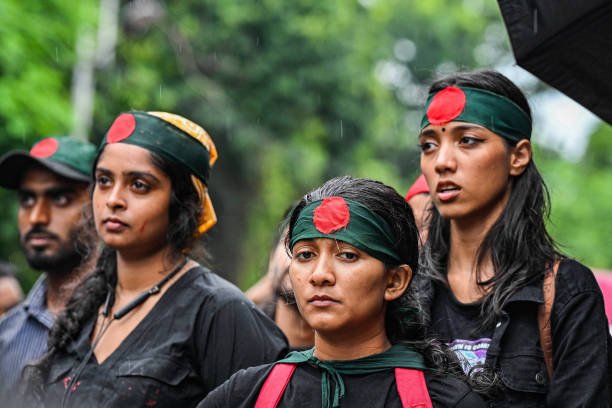 Protesters seen wearing Bangladesh flag headbands during a