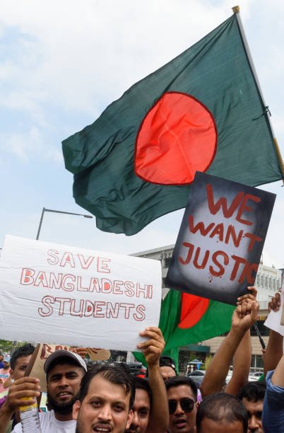 Bangladeshis residents in South Korea hold placards during a