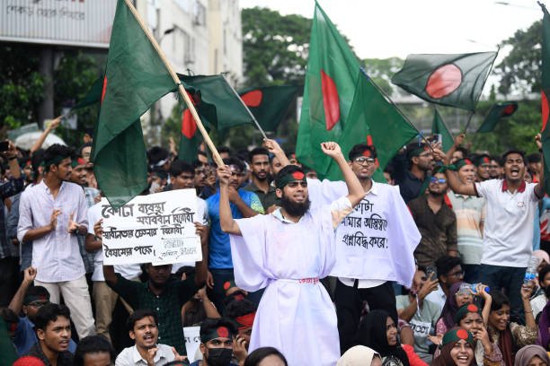 Protesters chant slogans and hold flags during a